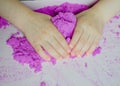 Kid`s hands with kinesthetic sand