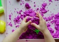 Kid`s hands with kinesthetic sand