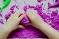 Kid`s hands with kinesthetic sand