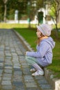 Girl-preschooler sitting on stone