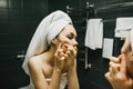 The girl presses pimples. Skin care