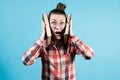 The girl presses two large books to her head and looks cautiously Royalty Free Stock Photo