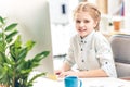 Girl pretending to be businesswoman and working with computer in office Royalty Free Stock Photo