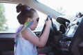 Girl pretending to drive a car Royalty Free Stock Photo