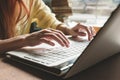 The girl prints on a white computer. Closeup of hands on the keyboard of a computer