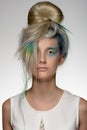 Girl with professional hair colouring and creative make up in peacock style