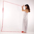 Girl white silk nightie making frame with red thread on white background