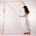 Girl white silk nightie making frame with red thread on white background