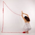 Girl squatting white silk nightie making frame with red thread on white background