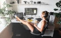 Girl programmer in the modern developer workplace for writing code with white computer desktop and comfy armchair.