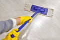 Girl in protective gloves cleaning floor using flat wet mop Royalty Free Stock Photo