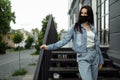 Girl in a protective mask on a balcony looks at an empty city Royalty Free Stock Photo