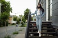 Girl in a protective mask on a balcony looks at an empty city Royalty Free Stock Photo