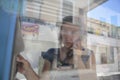 Girl on a public payphone cabin from outside Royalty Free Stock Photo