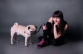 Girl with pug dog in studio Royalty Free Stock Photo