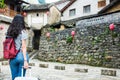 Girl pulling the suitcase walking in the ancient town Royalty Free Stock Photo