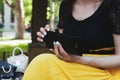 Girl pulls money out of wallet in the park Royalty Free Stock Photo