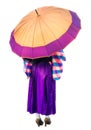 A girl in a purple dress standing under lilac umbrella. Back view of woman in kimono holding big umbrella isolated on