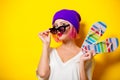 Girl in purple hat holding a flip flops Royalty Free Stock Photo