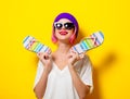 Girl in purple hat holding a flip flops Royalty Free Stock Photo