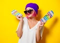 Girl in purple hat holding a flip flops Royalty Free Stock Photo