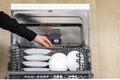 Girl pushing in drawer full of tableware