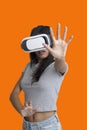 Girl put her hands to catch something while playing multimedia game with virtual reality glasses Royalty Free Stock Photo