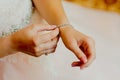 Girl puts on a bracelet with stones, morning of the bride