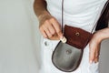 Girl puts a coin in the leather purse. Royalty Free Stock Photo