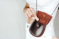 Girl puts a coin in the leather purse. Royalty Free Stock Photo