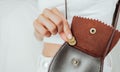 Girl puts a coin in the leather purse. Royalty Free Stock Photo