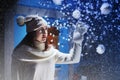 Girl puts decorations on the Christmas tree in a snow day