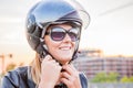 Girl puts on a helmet to go on a scooter