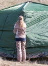 Girl puts a tent on the nature