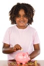 Girl putting a coin in a piggy bank Royalty Free Stock Photo