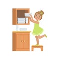 Girl Putting The Plates In Cupboard