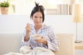 Girl in pyjama having cereal breakfast on couch