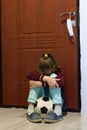 Girl in quarantine period is tortured sitting with a ball at the front door