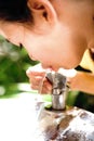 Girl quenching thirst at water cooler Royalty Free Stock Photo