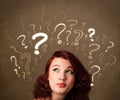 Girl with question mark symbols around her head Royalty Free Stock Photo