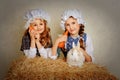 Girl with a rabbit on the hay and a carrot. Royalty Free Stock Photo