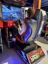 Woman driving a racing game. Girl on a racing car simulator. Concept: computer games, car racing. Kyiv, Galaxy amusement park, Royalty Free Stock Photo