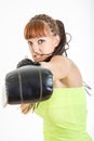 Girl in rage wearing boxing gloves ready to fight and punching o Royalty Free Stock Photo