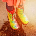 Girl in rain boots is standing in a puddle Royalty Free Stock Photo