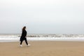 Girl rain sea wind winter portrait woman smile spring coat long hair curly mood shore snow beach autumn deadpan Royalty Free Stock Photo