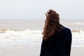 Girl rain sea wind winter portrait woman smile spring coat long hair curly mood shore snow beach