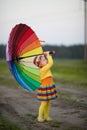 girl with rainbow umrella in the field Royalty Free Stock Photo