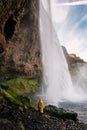 Girl in raincoat and waterfall. Iceland Royalty Free Stock Photo