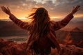 The girl raised her hands to the sun against the backdrop of the mountains. Healthy lifestyle, travel concept