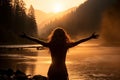 The girl raised her hands to the sun against the backdrop of the mountains. Healthy lifestyle, travel concept